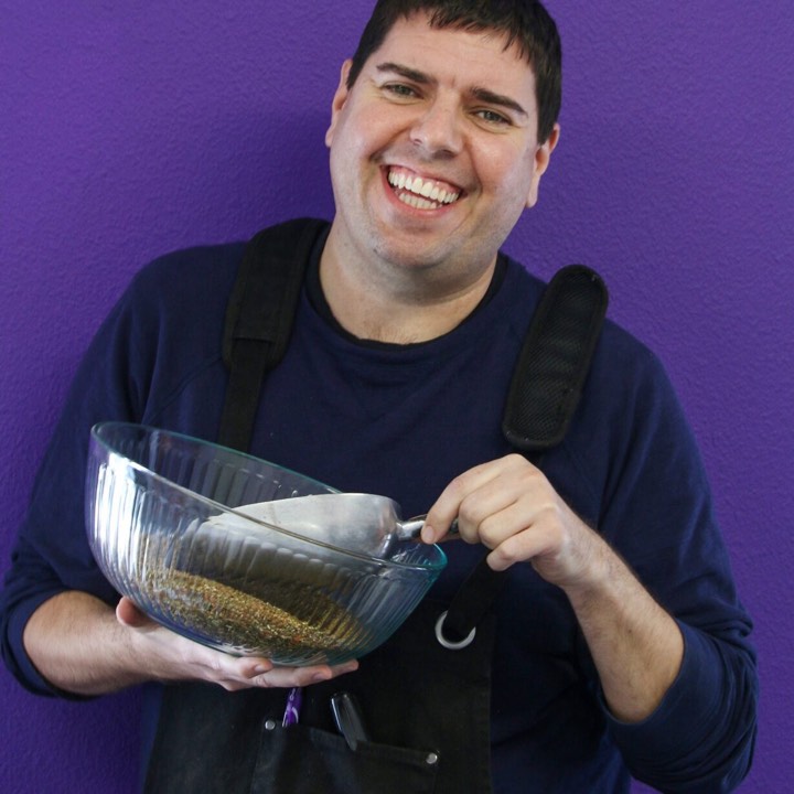 Andy Hayes, Plum Deluxe's founder, holding a bowl of loose-leaf tea