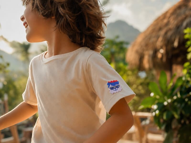 A child wearing a NatPat patch on their t-shirt sleeve